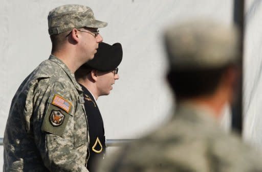 PFC Bradley Manning (C) is escorted by military police as he enters the courtroom at Fort Meade, Maryland for his court martial hearing on April 25. A US military judge ruled Thursday that WikiLeaks suspect Manning can be tried for "aiding the enemy" over allegedly leaking documents to the site -- a charge that carries a potential life sentence