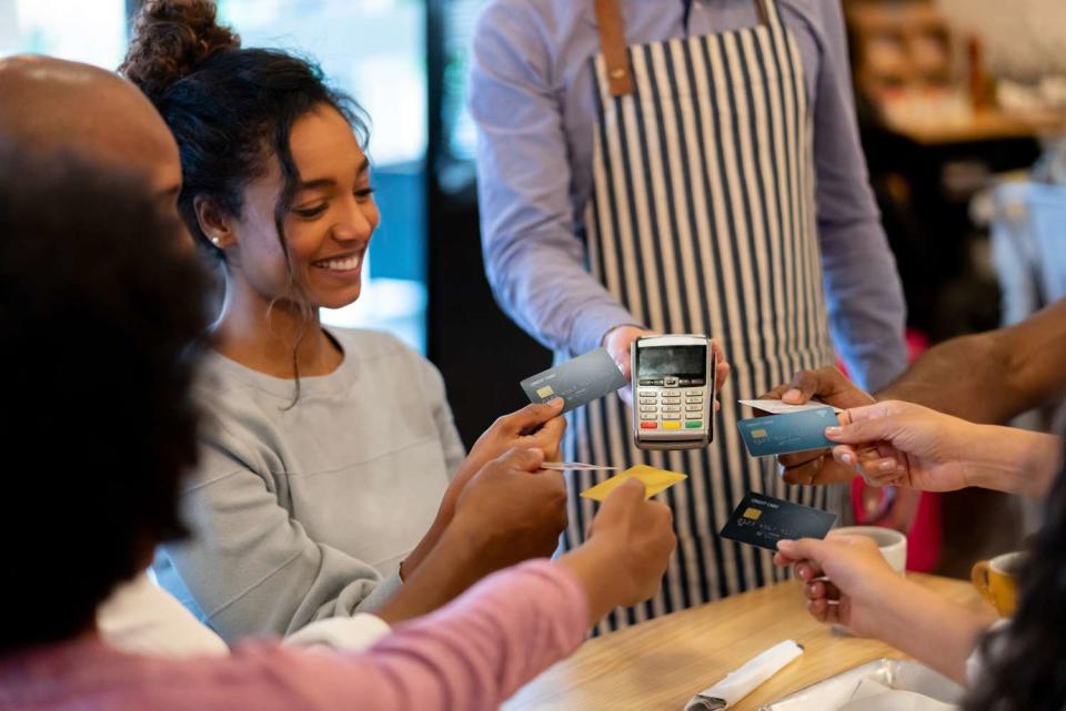 <p>Getty</p> Stock image of a group splitting the bill