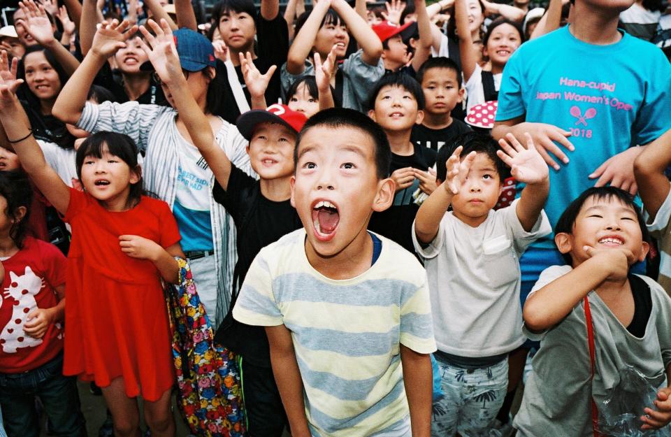 The younger children prepare to receive rice cakes, which are thrown as part of the ceremony.