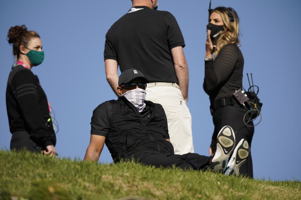 Tiger Woods is seen looking down at the 18th hole from the practice green during the final round of the Genesis Invitational golf tournament at Riviera Country Club, Sunday, Feb. 21, 2021, in the Pacific Palisades area of Los Angeles. (AP Photo/Ryan Kang)