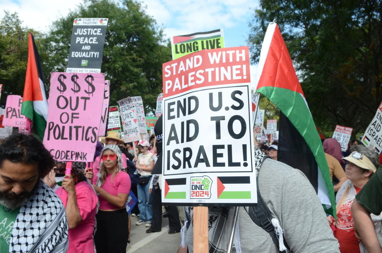 Pro-Palestinian demonstrators hold signs reading: Stand with Palestine! End U.S. aid to Israel!