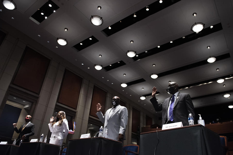 From left, Paul Butler, Angela Underwood Jacobs, Philonise Floyd, and Ben Crump are sworn in during a House Judiciary Committee hearing on proposed changes to police practices and accountability on Capitol Hill, Wednesday, June 10, 2020, in Washington. (Brendan Smialowski/Pool via AP)