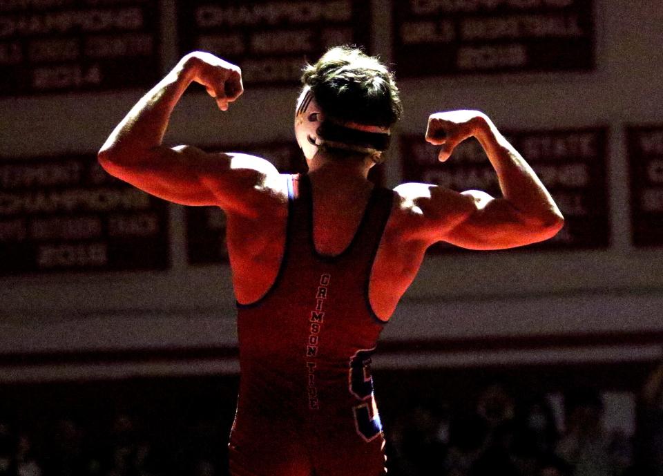 Spaulding's Nick Pierce flexes in the spotlight after claiming the 126 pound title at the State Championships on Sunday night at CVU.