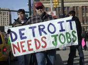 Chrysler Transport worker James Theisen carries a "Detroit Needs Jobs" sign as he joins a demonstration of about a dozen workers demanding jobs, in front of Cobo Center in Detroit, REUTERS/Rebecca Cook