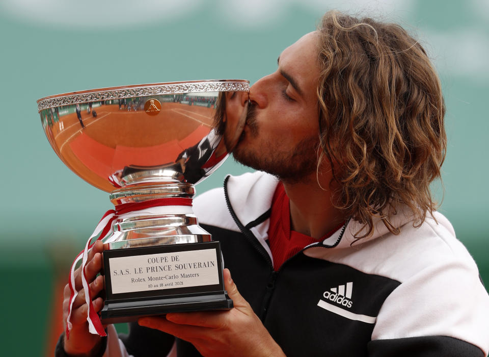 Stefanos Tsitsipas of Greece kisses the trophy after defeating Andrey Rublev of Russia in the Monte Carlo Tennis Masters tournament finals in Monaco, Sunday, April 18, 2021. (AP Photo/Jean-Francois Badias)