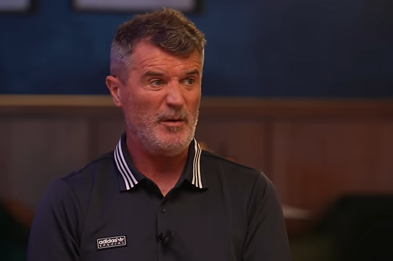 Roy Keane speaking into a microphone