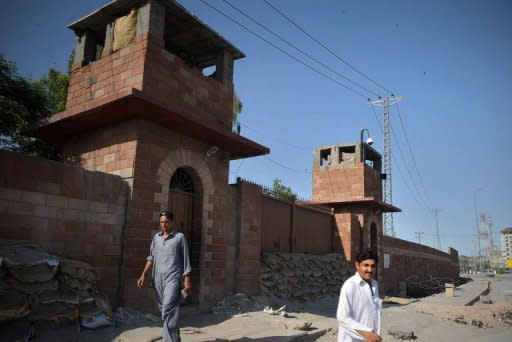 Pedestrians walk past the Peshawar central jail where Pakistani surgeon Shakeel Afridi, who worked for US intelligence, was moved after being sentenced to 33 years in prison for treason