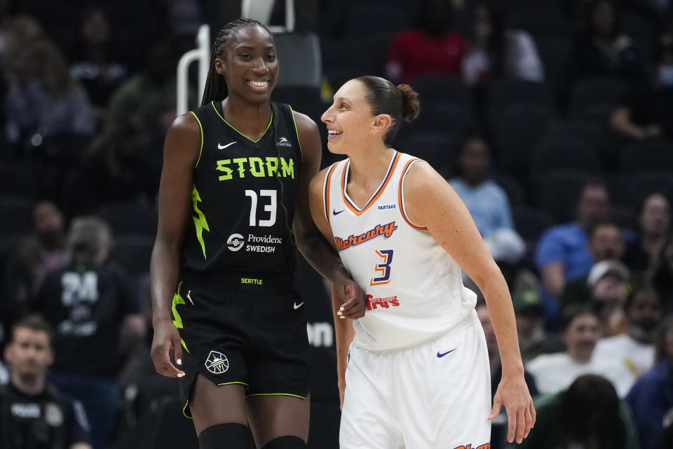 Seattle Storm center Ezi Magbegor (13) and Phoenix Mercury guard Diana Taurasi (3) smile during a stoppage in play during the second half of a WNBA basketball game Tuesday, June 4, 2024, in Seattle. The Storm won 80-62. (AP Photo/Lindsey Wasson)