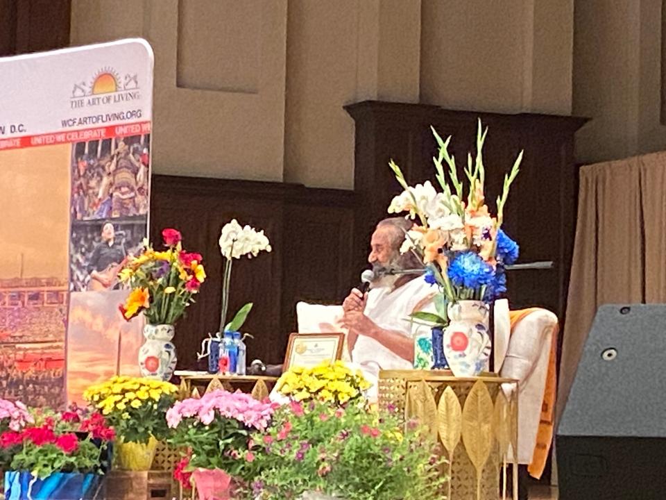 Gurudev Sri Sri Ravi Shankar sits on stage speaking to about 1,200 people at Orchestra Hall in Detroit on August 22, 2023.
