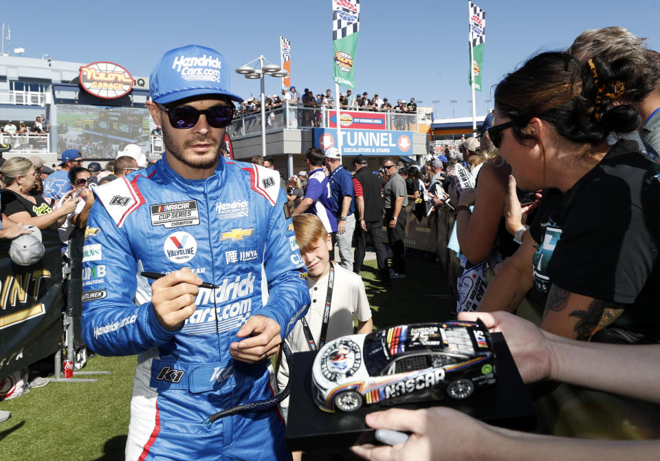 Kyle Larson signs autographs for fans before a NASCAR Cup Series auto race, Sunday, Oct. 15, 2023, in Las Vegas. (AP Photo/Steve Marcus)