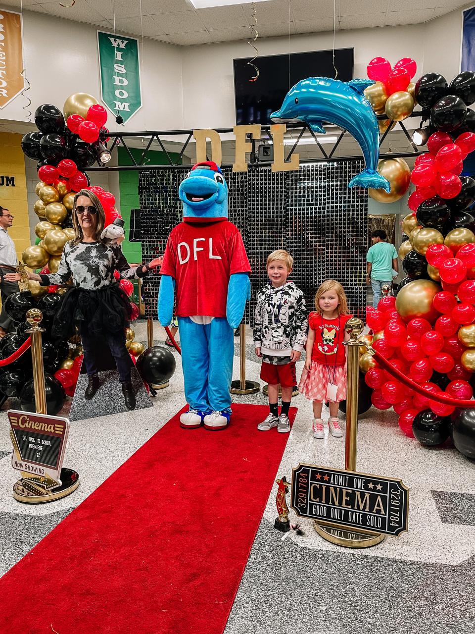 Dogwood Elementary School’s mascot poses with Madison and Hunter Lange at the Back to School Premiere event on Aug. 3, 2022.