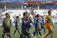 <p>Japanese players applaud supporters after they qualified second in Group H, despite losing to Poland </p>