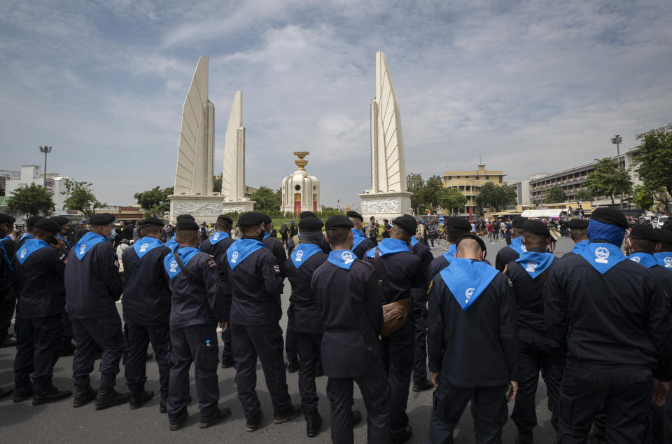 Police stand guard as anti-government protesters rally near the Democracy Monument in Bangkok, Thailand, Wednesday, Oct. 14, 2020. Anti-government protesters began gathering Wednesday for a planned rally at Bangkok’s Democracy Monument being held on the anniversary of a 1973 popular uprising that led to the ousting of a military dictatorship, amid a heavy police presence and fear of clashes with political opponents. (AP Photo/Sakchai Lalit)