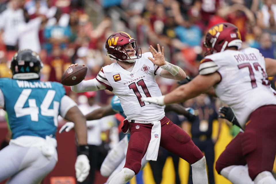 Washington Commanders quarterback Carson Wentz (11) throwing the ball during the second half of an NFL football game against the Jacksonville Jaguars, Sunday, Sept. 11, 2022, in Landover, Md. (AP Photo/Patrick Semansky)