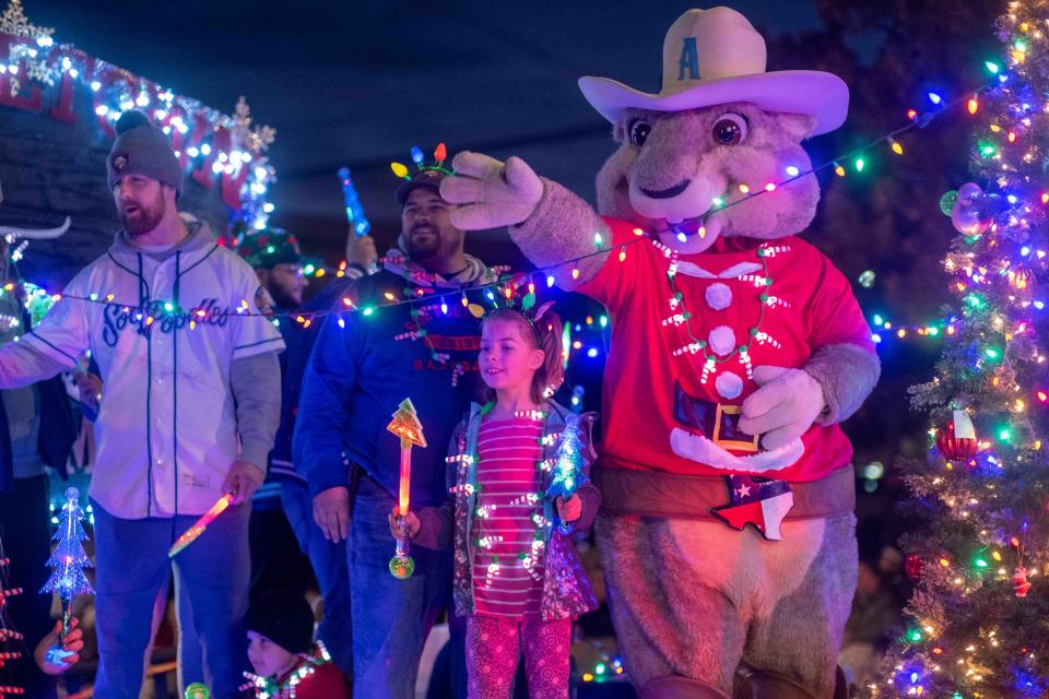 Ruckus, the Sod Poodles mascot, greets the crowd on Polk Street during the 2022 Center City Electric Light Parade in downtown Amarillo. This year's parade will be held Dec. 1.
