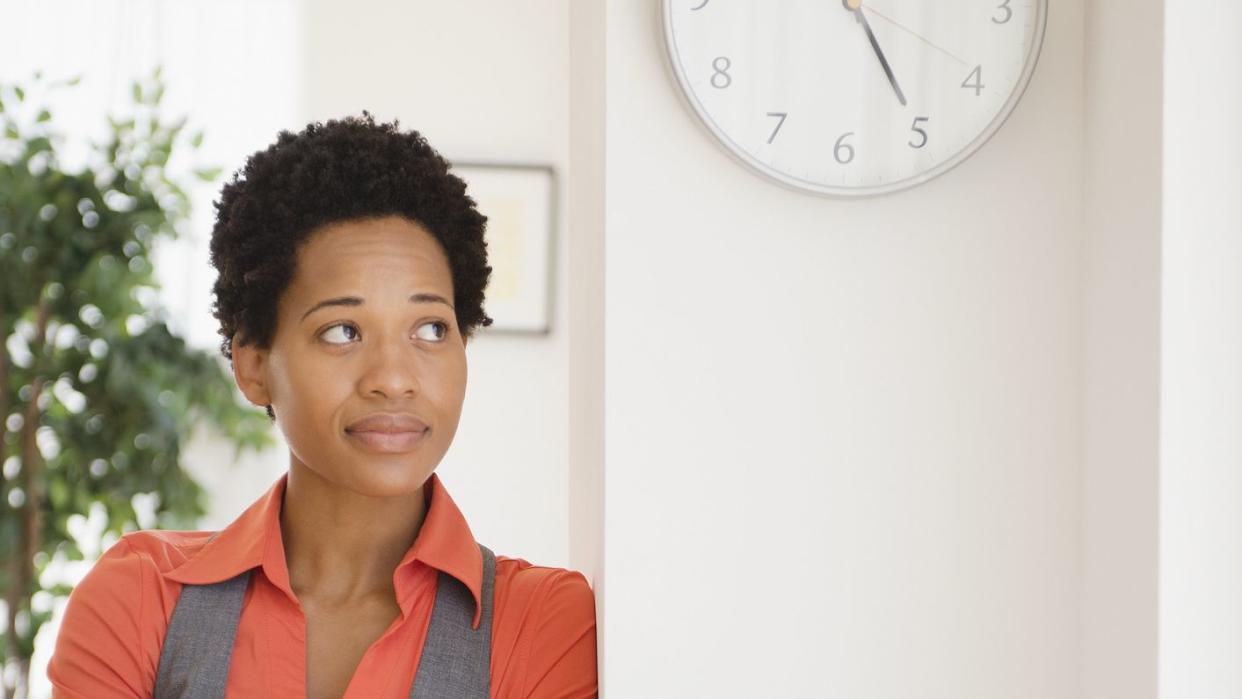 impatient african american businesswoman leaning against wall