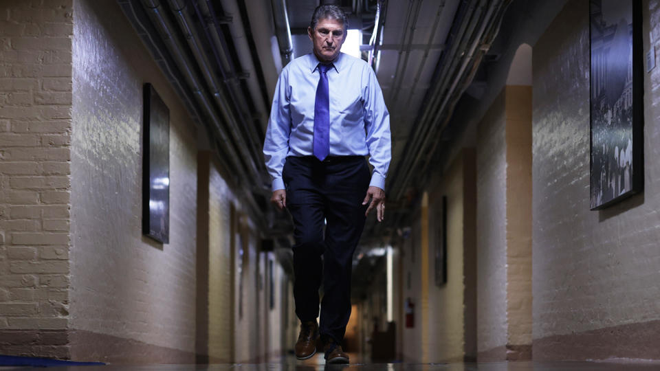 Sen. Joe Manchin, D-W.Va., walks through a hallway in the basement of the U.S. Capitol.