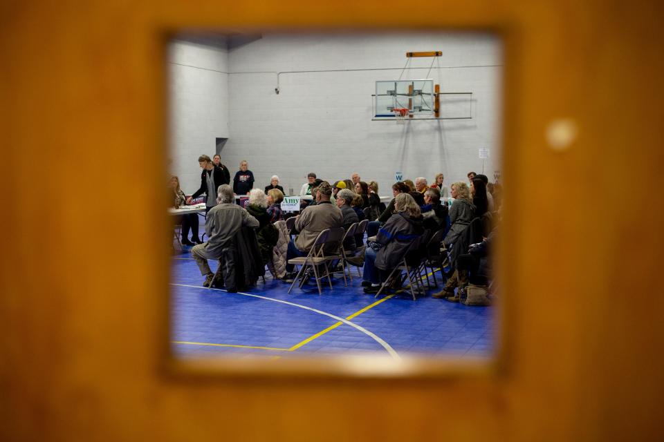 People gather for the Democratic presidential caucus on Monday, Feb. 3, 2020, in Larchwood, Iowa.