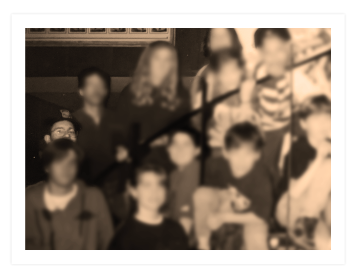 In many group photos taken through the years, David Menna appears in the back, all but obscured by one of the youths.