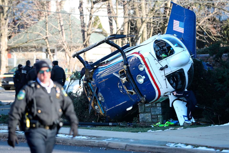 A medical helicopter rests next to the Drexel Hill United Methodist Church after it crashed in the Drexel Hill section of Upper Darby Township in Delaware County, Pa., on Tuesday, Jan. 11, 2022. {Monica Herndon/The Philadelphia Inquirer via AP]