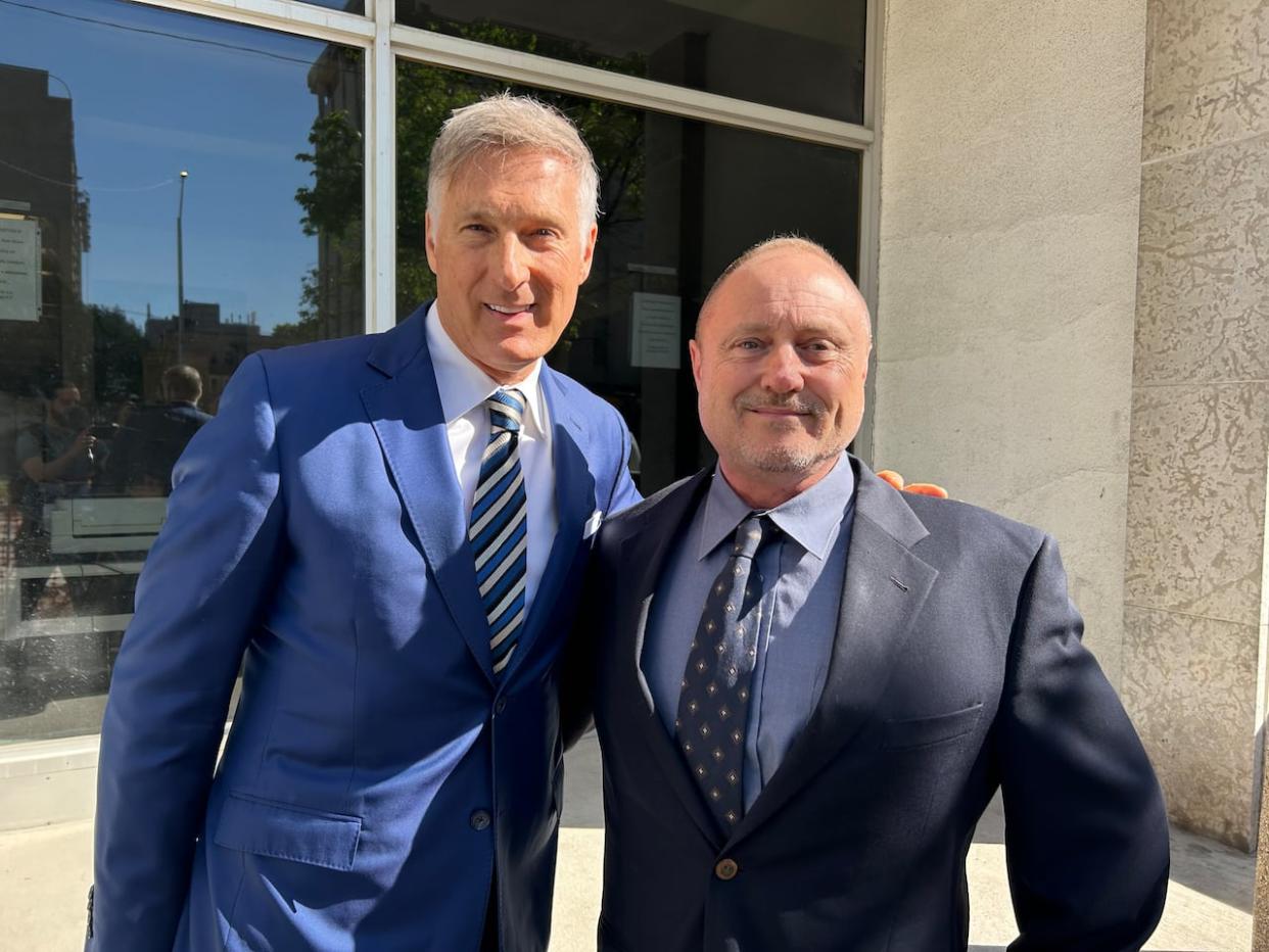 Todd Dube, right, ahead of his court appearance in Winnipeg on Wednesday. He lost his fight to have a fine thrown out that he received for contravening COVID-19 public health orders in 2021, when he attended a rally for People's Party of Canada Leader Maxime Bernier, left. (Bryce Hoye/CBC - image credit)