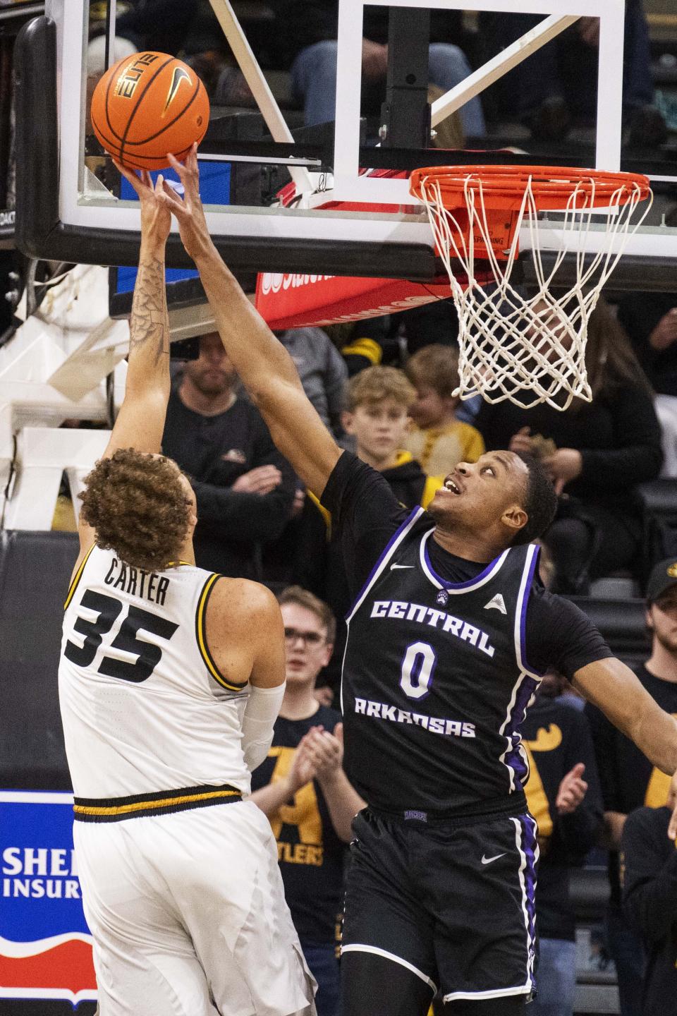 Central Arkansas' Ubongabasi Etim, right, blocks the shot of Missouri's Noah Carter, left, during the first half of an NCAA college basketball game Saturday, Dec. 30, 2023, in Columbia, Mo. (AP Photo/L.G. Patterson)