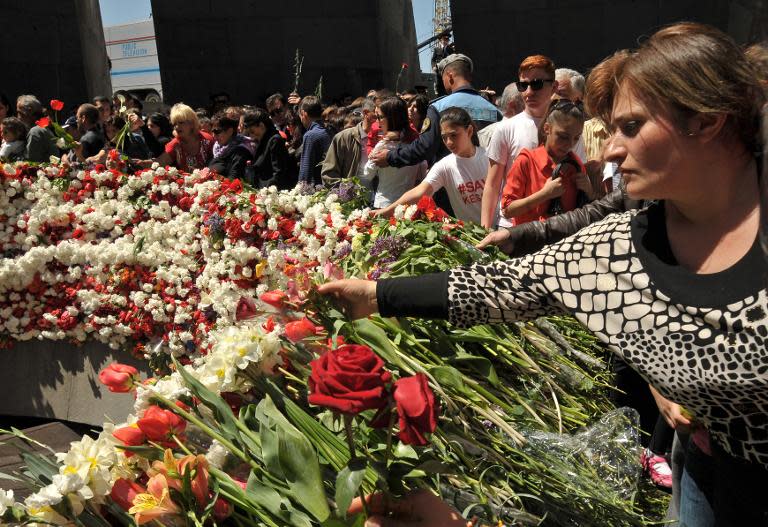 People lay flowers at the monument dedicated to the thousands of Armenians killed by Ottoman Turks during World War I, during a ceremony in Yerevan, on April 24, 2014