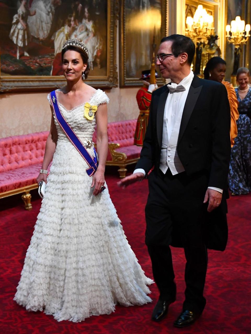 <p><a href="https://www.townandcountrymag.com/style/fashion-trends/a27682334/kate-middleton-jewelry-dress-buckingham-palace-state-banquet-donald-trump/" rel="nofollow noopener" target="_blank" data-ylk="slk:Kate wore a tiered Alexander McQueen gown to a state banquet with Donald Trump;elm:context_link;itc:0;sec:content-canvas" class="link ">Kate wore a tiered Alexander McQueen gown to a state banquet with Donald Trump</a>. She paired the dress with the Lover's Knot Tiara, and the Queen Mother's sapphire and diamond fringe earrings.</p>