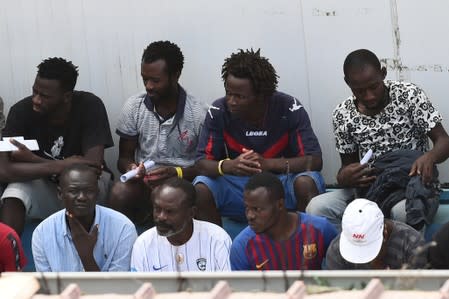 Migrants, some of whom disembarked from Spanish rescue ship Open Arms NGO, are seen at the immigration centre on the southern Sicilian island of Lampedusa