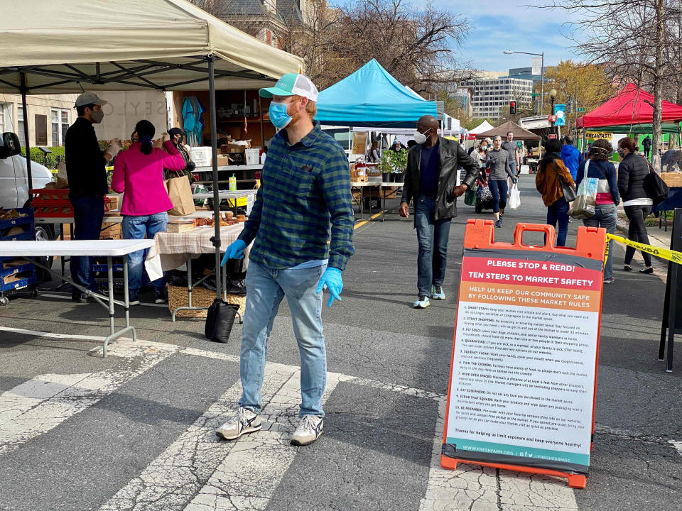 Image: Customers wearing masks walk through the Dupont Circle Market in Washington (Daniel Slim / AFP - Getty Images)