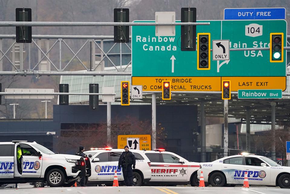 Law enforcement personnel block off the entrance to the Rainbow Bridge, Wednesday, Nov. 22, 2023, in Niagara Falls, N.Y. The border crossing between the U.S. and Canada has been closed after a vehicle exploded at a checkpoint on a bridge near Niagara Falls.