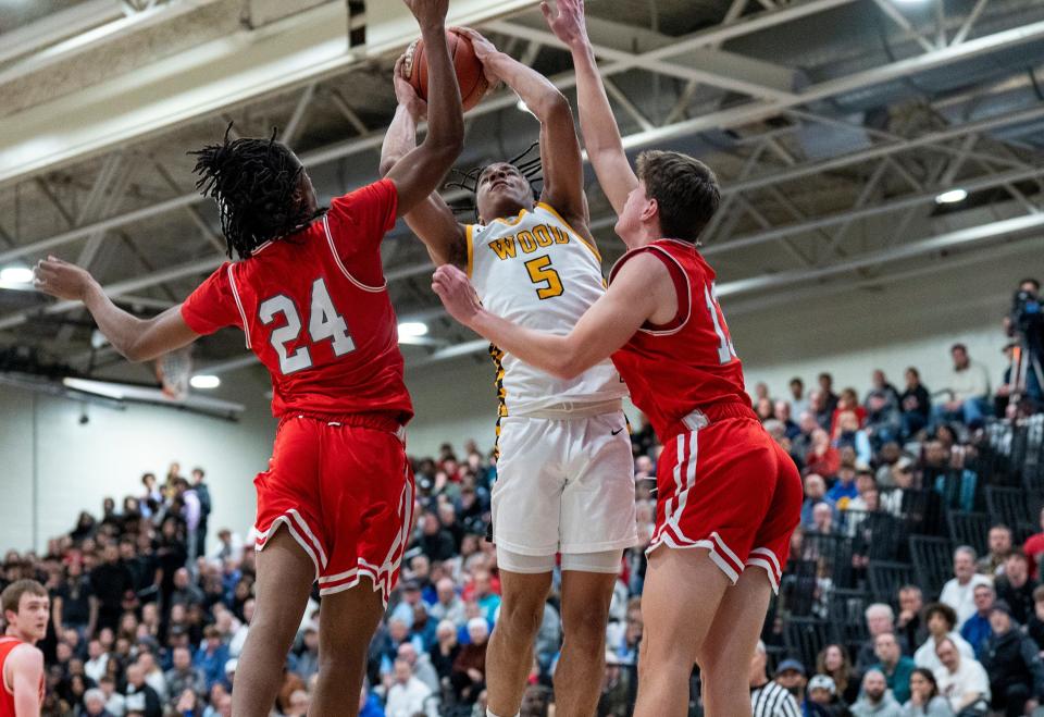 Archbishop Wood's Josh Reed (5) scores inside against Parkland's Chayce Taylor (24) and Robbie Ruisch (13) during Tuesday's state semifinal game at Norristown.