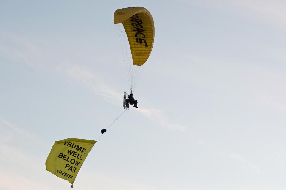 <p>A Greenpeace protester flying a microlight paraglider-style aircraft passes over President Trump’s golf resort in Turnberry, South Ayrshire, with a banner reading “Trump: Well Below Par” shortly after the president arrived at the hotel. (Photo: John Linton/PA Images via Getty Images) </p>