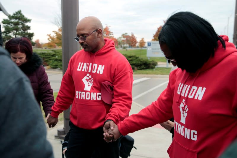 Striking United Auto Worker (UAW) Joe Ryan leads a prayer circle on the picket line outside the General Motors Detroit-Hamtramck Assembly in Hamtramck