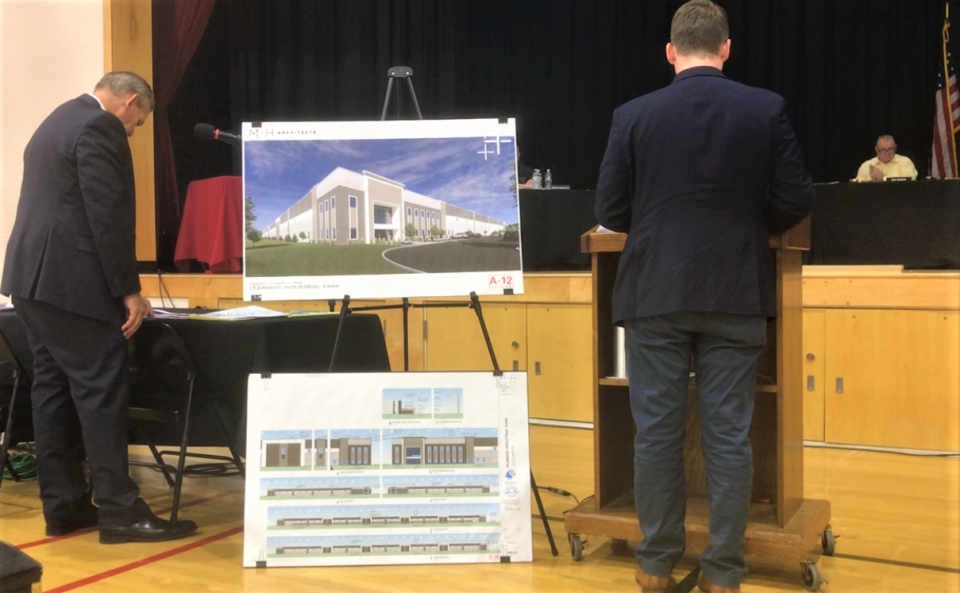 Attorney Clint Allen (left) and architect Zack Wester testify Thursday night before the Woolwich Township Joint Land Use Board on the Oldmans Industrial Park proposed for Auburn Road. The exhibits between them are renderings of the proposed warehouse. PHOTO: June 29, 3023.