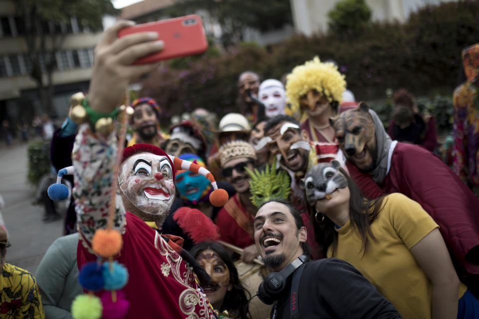 Members of the Brazilian theater group Clowns of Shakespeare take a selfie as they perform in Bogota, Colombia, Saturday, Oct. 26, 2019. The troupe's play titled “Abrazo,” or Hug, is among the growing list of shows, plays, conferences and other artistic projects that have been abruptly canceled in Brazil since the nation's President Jair Bolsonaro took office Jan. 1, after the troupe talked politics with the audience during the show’s debut. (AP Photo/Ivan Valencia)