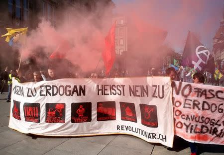 People hold banners and flags during a demonstration against Erdogan dictatorship and in favour of democracy in Turkey in Bern, Switzerland March 25, 2017. The bannerr reads "Say no to Erdogan" REUTERS/Ruben Sprich