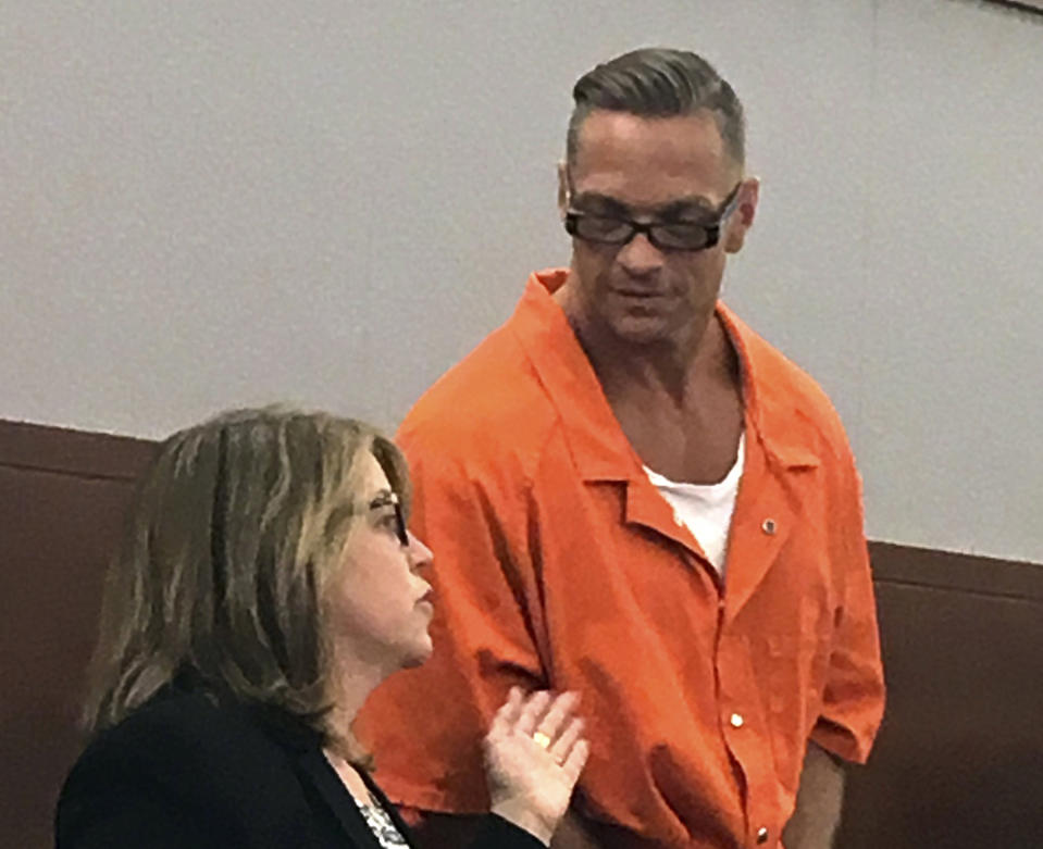 FILE - In this Aug. 17, 2017, file photo, Nevada death row inmate Scott Dozier, right, confers with Lori Teicher, a federal public defender involved in his case, during an appearance in Clark County District Court in Las Vegas. The Nevada Supreme has rescheduled oral arguments for Sept. 21, 2018, in Carson City on a challenge by three pharmaceutical companies of the use of their products for Dozier's execution. Prison officials want to reschedule Dozier's twice-postponed lethal injection for mid-November. (AP Photo/Ken Ritter, File)