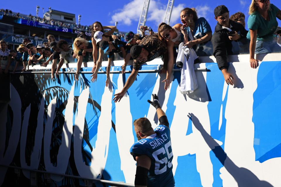 Jacksonville Jaguars center Tyler Shatley (69) high-fives fans after the game an NFL football matchup Sunday, Oct. 15, 2023 at EverBank Stadium in Jacksonville, Fla. The Jacksonville Jaguars defeated the Indianapolis Colts 37-20. [Corey Perrine/Florida Times-Union]