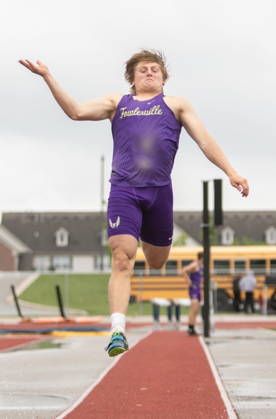 Fowlerville's Jack Shrader tied for first place in the long jump at the CAAC Red track and field meet Wednesday, May 25, 2022 at Lansing Eastern.