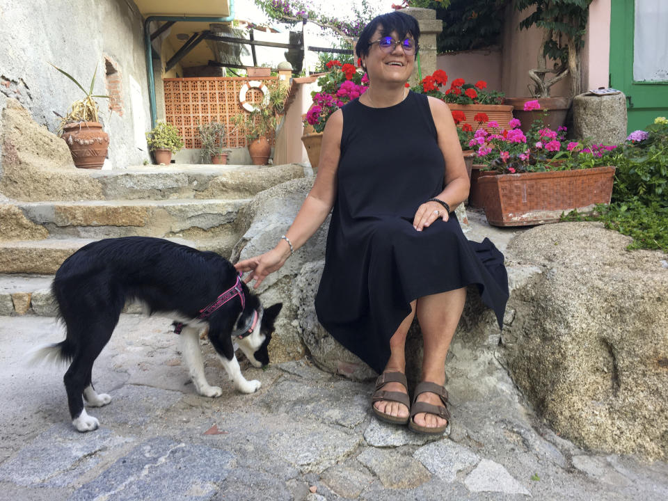 Italian scientist Paola Muti Paola Muti poses after an interview in her home at the Giglio Island, Italy, Tuesday, June 23, 2020. Muti was stranded on the tiny island where mainlanders sick with COVID-19 came ashore but no islanders apparently took ill. So she decided to do a scientific study to find out why. (AP Photo/Paolo Santalucia)