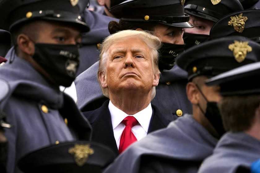 Surrounded by Army cadets, President Donald Trump watches the first half of the 121st Army-Navy Football Game in Michie Stadium at the United States Military Academy, Saturday, Dec. 12, 2020, in West Point, N.Y. (AP Photo/Andrew Harnik)