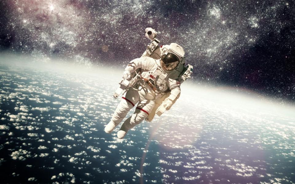 Astronaut in space against the backdrop of the planet Earth