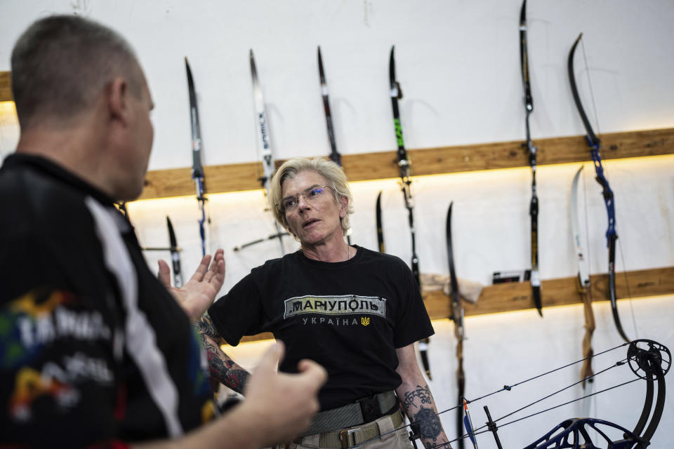 Ukrainian medic Yuliia Paievska, known as Taira, speaks to a coach during archery training in Kyiv, Ukraine, on Friday, July 8, 2022. The celebrated Ukrainian medic who was held captive by Russian forces says she thinks about the prisoners she left behind constantly. Before she was captured, Paievska had recorded harrowing bodycam footage showing her team's efforts to save the wounded in the besieged city of Mariupol. (AP Photo/Evgeniy Maloletka)