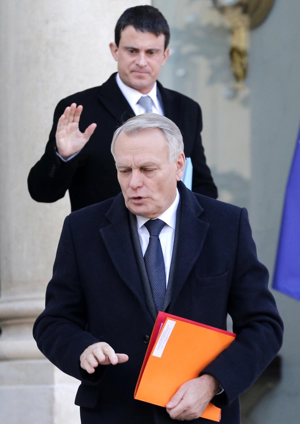 FILE - In this Jan. 14, 2013 file photo, French Prime Minister Jean-Marc Ayrault, foreground, and Interior Minister Manuel Valls leave the Elysee Palace, in Paris. French President Francois Hollande is preparing a probable shake-up of his unpopular government after his Socialist Party suffered losses in nationwide municipal elections seen as a referendum on his leadership. Disappointment with the Socialists' handling of the economy drove many voters to conservative or anti-immigrant far-right candidates in nationwide municipal elections Sunday. Hollande met Monday morning Prime Minister Jean-Marc Ayrault, according to officials who spoke on condition of anonymity because the talks were not meant to be public knowledge. (AP Photo/Christophe Ena, File)