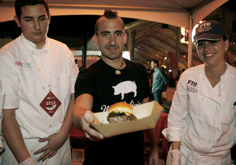 Chef Marc Forgione shows off his The Hangover 2 Burger while competing in the Burger Bash at the Food Network South Beach Wine & Food Festival in Miami Beach, Friday, Feb. 24, 2012.(AP photo/Jeffrey M. Boan)