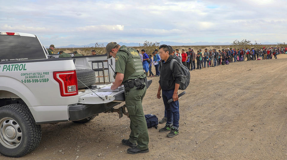 EDITORS ELIMINATE FROM YOUR SYSTEMS AND ARCHIVES PHOTO LA512 SLUGGED BORDER ARREST TRANSMITTED JAN. 18, 2019. THE PHOTO HAS BEEN MANIPULATED BY THE SOURCE - This Monday, Jan. 14, 2019 photo released by U.S. Customs and Border Protection shows some of 376 Central Americans the Border Patrol says it arrested in southwest Arizona, the vast majority of them families, who used short holes dug under a barrier to cross the border in multiple spots about 10 miles east of San Luis, Ariz. The unusually large group was almost entirely from Guatemala. (U.S. Customs and Border Protection via AP)