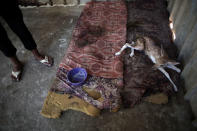 <p>A Palestinian worker stands next to an ill baby deer lays on mattresses in a metal cage in a zoo in Khan Younis , southern Gaza Strip, Friday, Aug. 19, 2016. (AP Photo/ Khalil Hamra) </p>