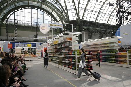 Models present creations by German designer Karl Lagerfeld as part of his Fall/Winter 2014-2015 women's ready-to-wear collection for French fashion house Chanel at the Grand Palais transformed into a "Chanel Shopping Center" during Paris Fashion Week March 4, 2014. REUTERS/Stephane Mahe