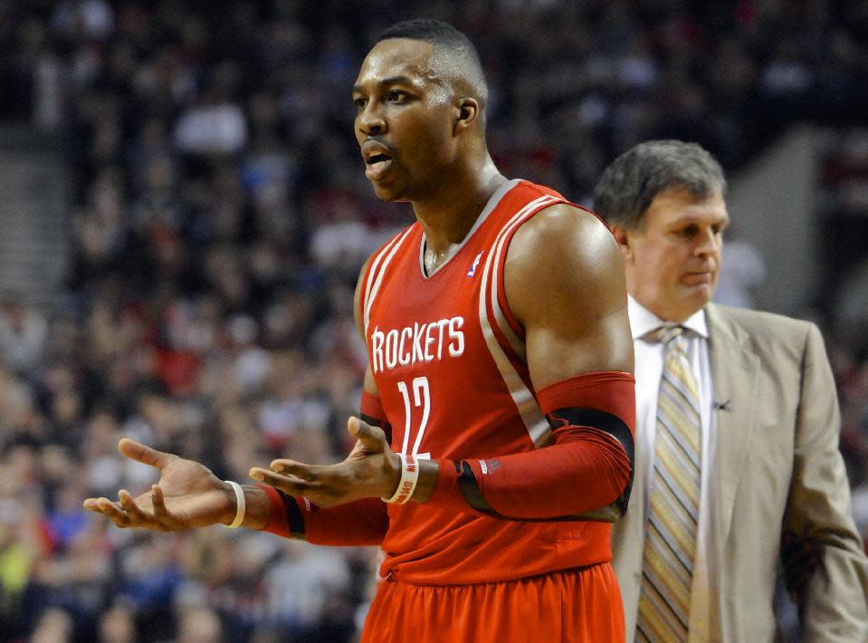 Houston Rockets' Dwight Howard (12) questions a technical foul called on him during the first half of game four of an NBA basketball first-round playoff series game against the Portland Trail Blazers in Portland, Ore., Sunday March 30, 2014. (AP Photo/Greg Wahl-Stephens)